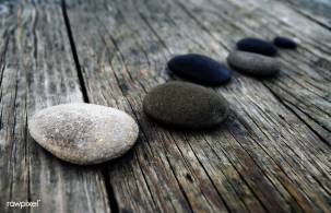 Smooth pebbles on wooden pier
